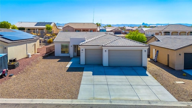 6102 S Scorpion Ln, Fort Mohave, AZ 86426 - view of front of property with a residential view, an attached garage, a tiled roof, concrete driveway, and stucco siding