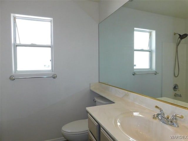 bathroom featuring bathtub / shower combination, vanity, and toilet