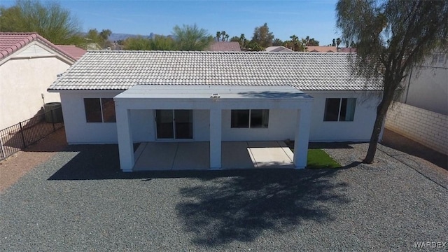 back of house featuring a patio area, fence, and stucco siding