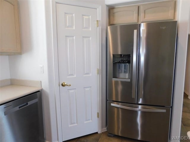 kitchen with light countertops, appliances with stainless steel finishes, and tile patterned floors