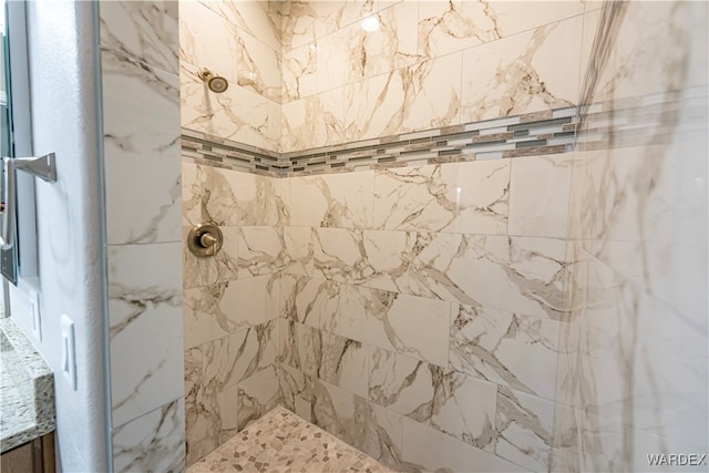 interior details with a tile shower