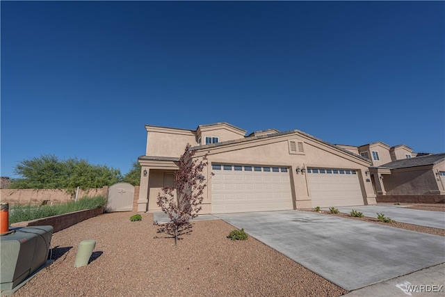 view of front of home with a garage, driveway, fence, and stucco siding