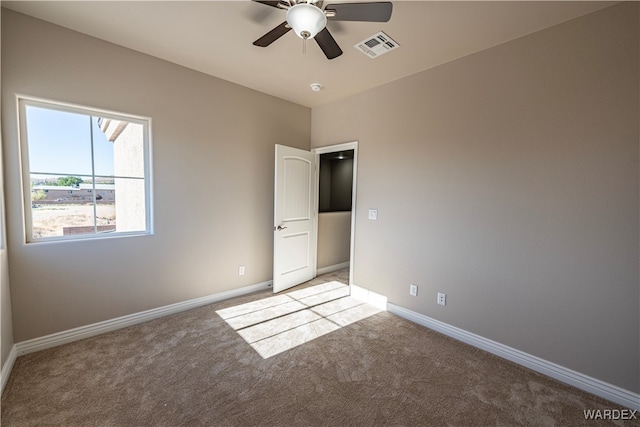 unfurnished bedroom with light carpet, ceiling fan, visible vents, and baseboards