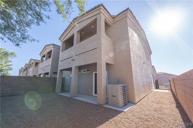 exterior space with central AC unit and fence