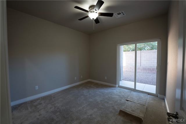 spare room with ceiling fan, carpet, visible vents, and baseboards