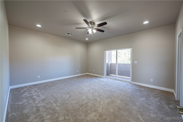 spare room featuring baseboards, visible vents, dark carpet, and recessed lighting