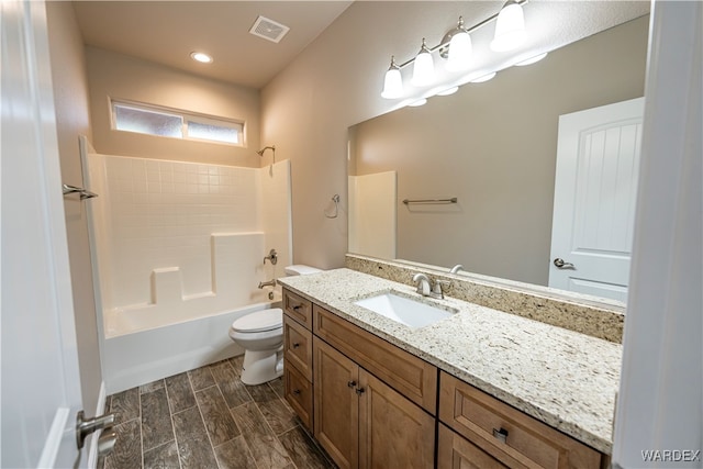 bathroom featuring shower / washtub combination, visible vents, toilet, wood tiled floor, and vanity