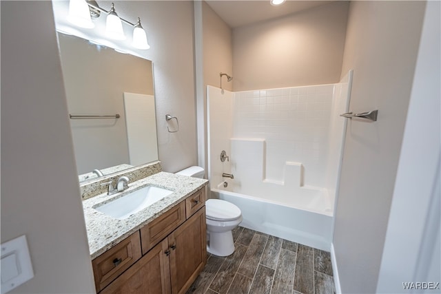 full bath with toilet, washtub / shower combination, vanity, and wood finish floors