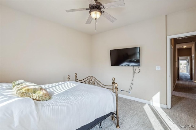 bedroom featuring light carpet, baseboards, and a ceiling fan