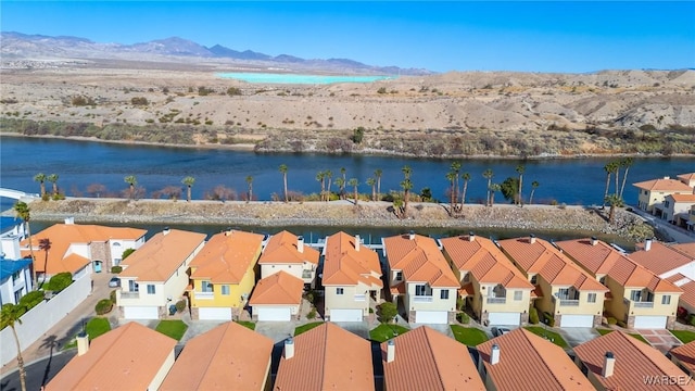 drone / aerial view featuring a residential view and a water and mountain view