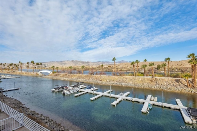 view of dock with a water and mountain view