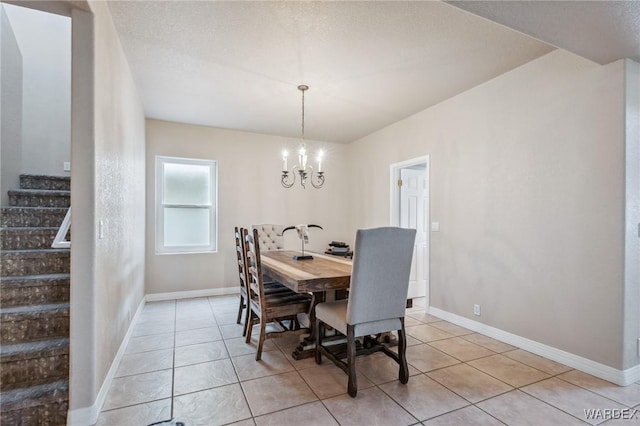 dining room with an inviting chandelier, light tile patterned floors, baseboards, and stairs