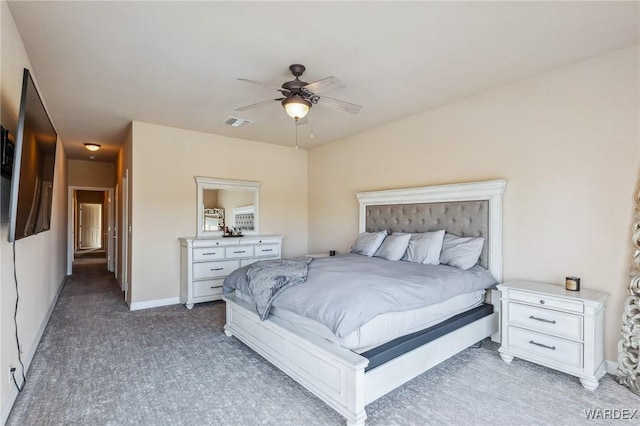 bedroom featuring visible vents, baseboards, dark colored carpet, and a ceiling fan