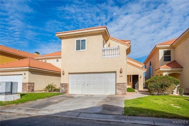 mediterranean / spanish-style house with stone siding, driveway, an attached garage, and stucco siding