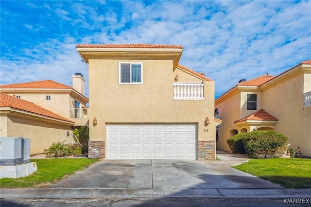 mediterranean / spanish-style home featuring a garage, stone siding, concrete driveway, and stucco siding