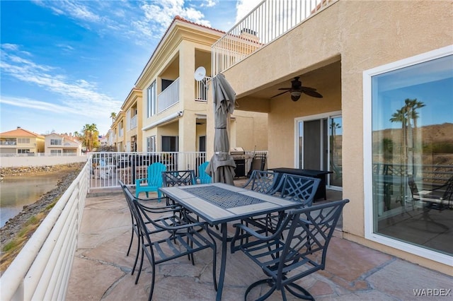 view of patio / terrace with outdoor dining area, a residential view, a balcony, and a ceiling fan