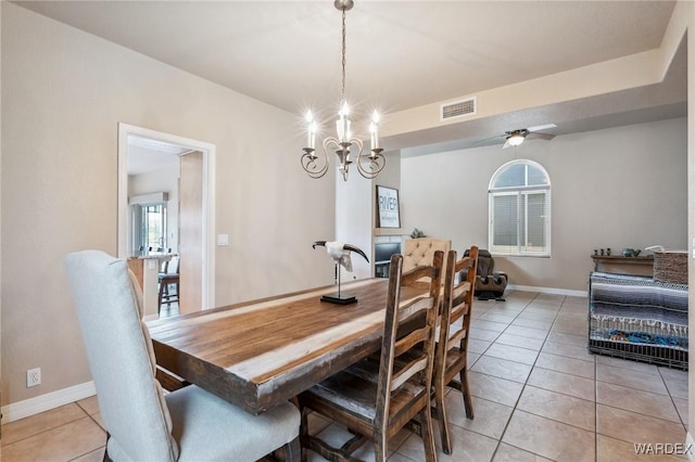 dining area featuring light tile patterned floors, visible vents, and baseboards