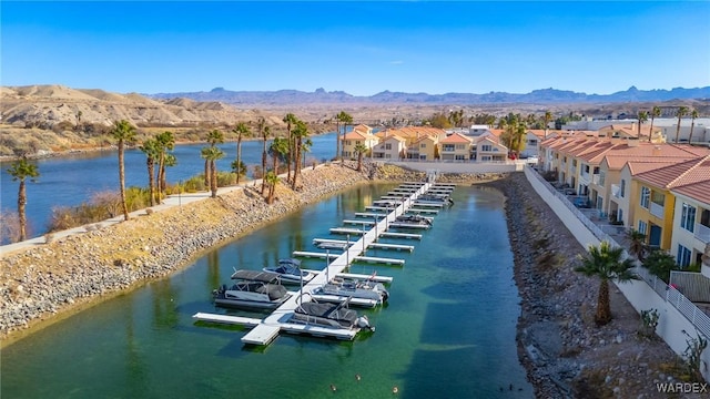 drone / aerial view with a residential view and a water and mountain view