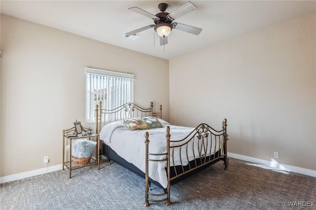 carpeted bedroom with a ceiling fan, visible vents, and baseboards