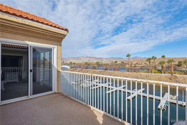 balcony with a water and mountain view