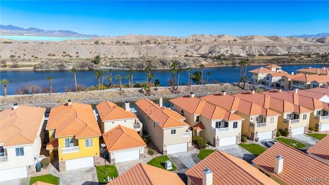 bird's eye view with a water and mountain view and a residential view