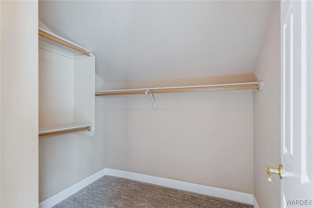 walk in closet with lofted ceiling