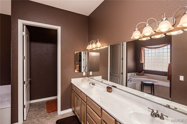 full bathroom featuring double vanity, tile patterned flooring, baseboards, and a sink