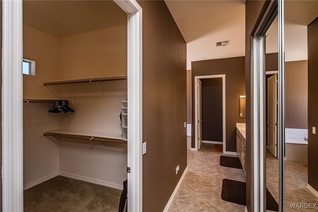 spacious closet featuring visible vents