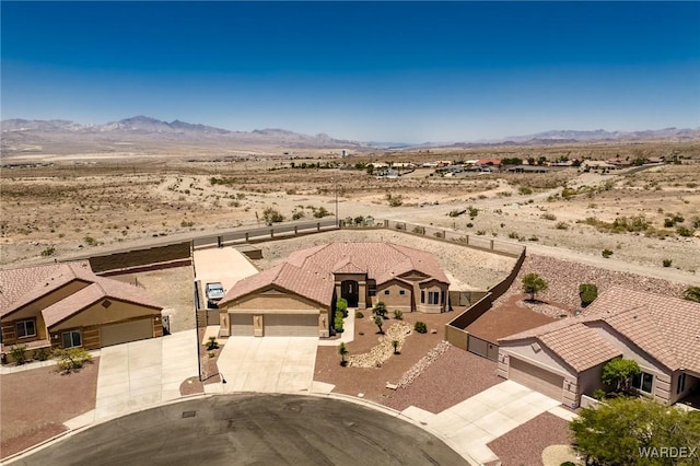 birds eye view of property with view of desert and a mountain view