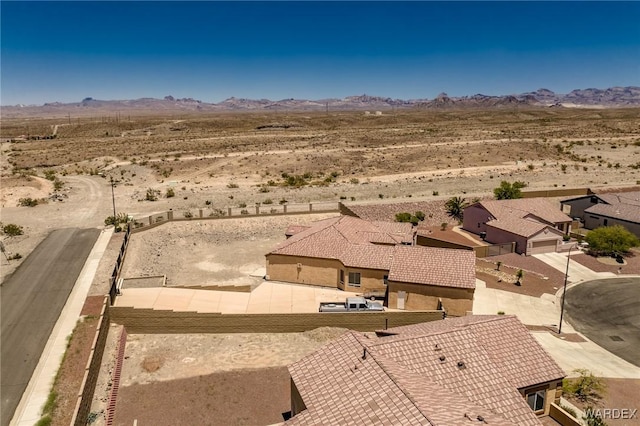 birds eye view of property featuring a mountain view and view of desert