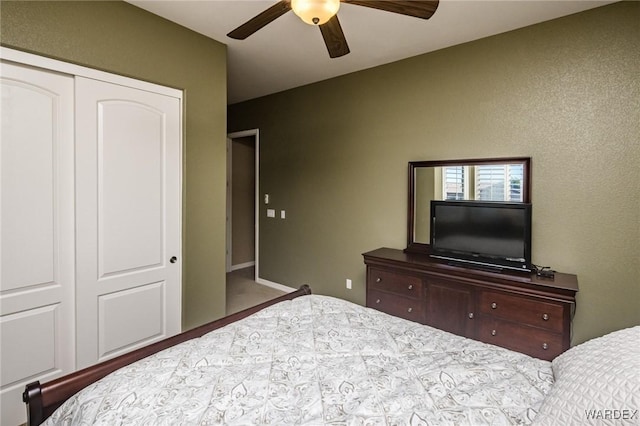 bedroom featuring ceiling fan and a closet