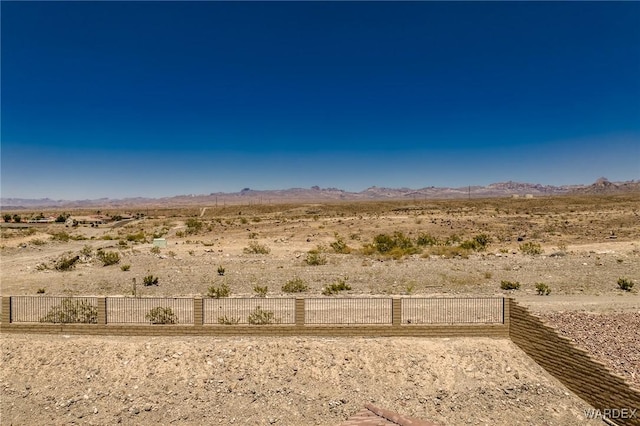 exterior space featuring a desert view and a mountain view