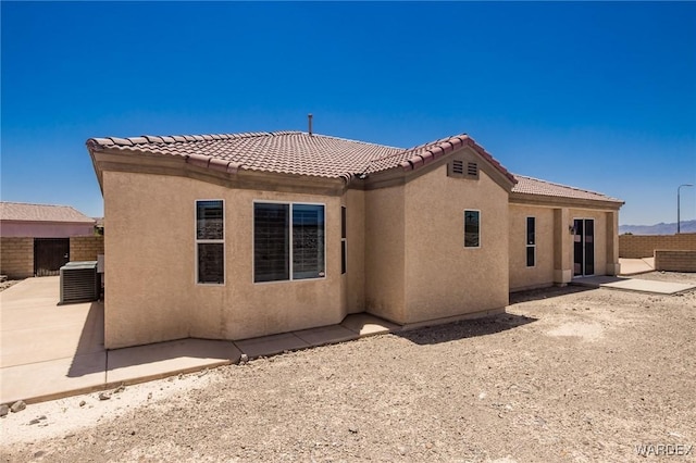 back of house with a patio, fence, a tiled roof, and stucco siding