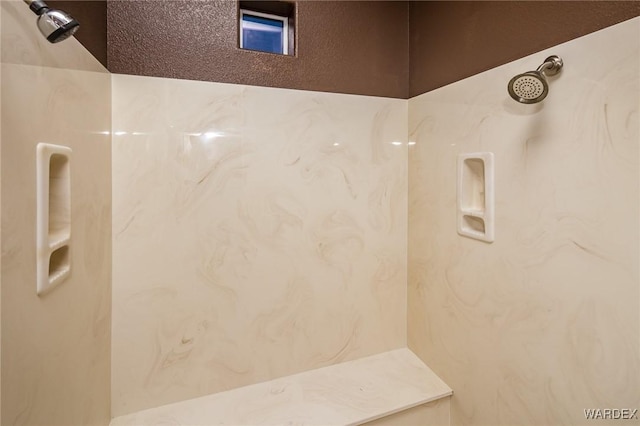 full bathroom with a marble finish shower