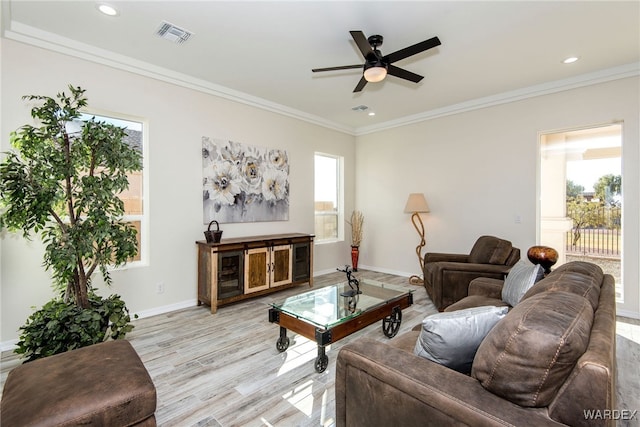 living room featuring baseboards, recessed lighting, visible vents, and crown molding