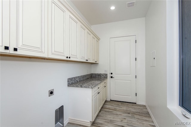 laundry room featuring recessed lighting, hookup for an electric dryer, visible vents, baseboards, and light wood finished floors