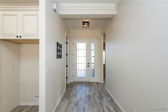 doorway to outside with light wood-style flooring and baseboards