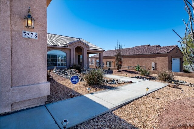 view of front of property with a tiled roof and stucco siding