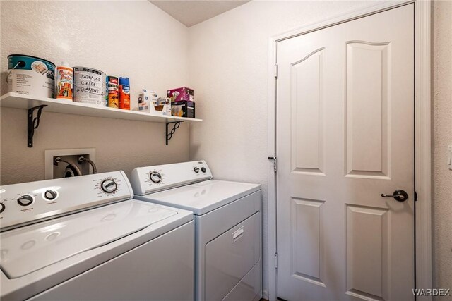 clothes washing area featuring laundry area and washing machine and clothes dryer