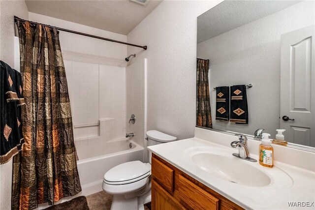 full bathroom featuring shower / tub combo, a textured wall, toilet, tile patterned floors, and vanity