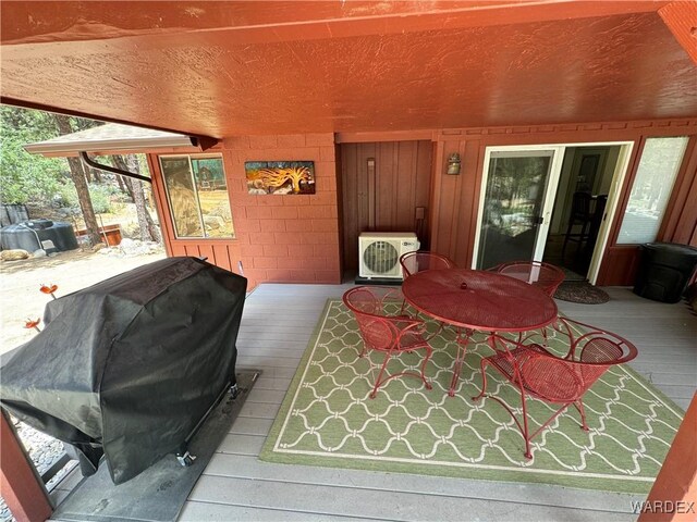 wooden terrace featuring ac unit and area for grilling