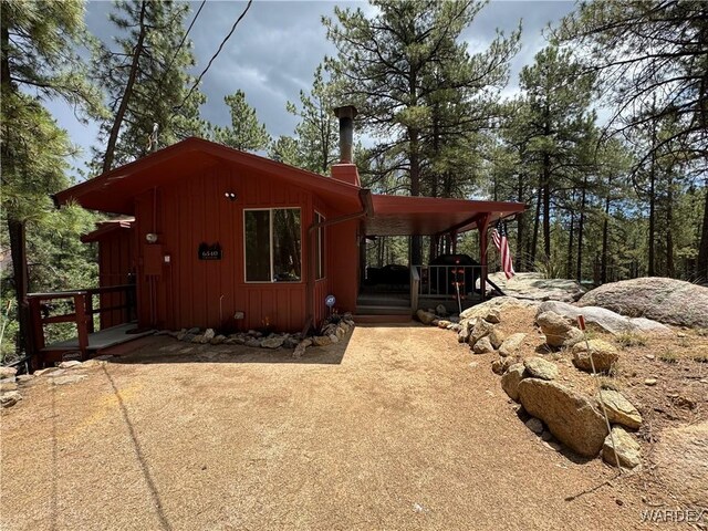 view of home's exterior featuring board and batten siding and a chimney