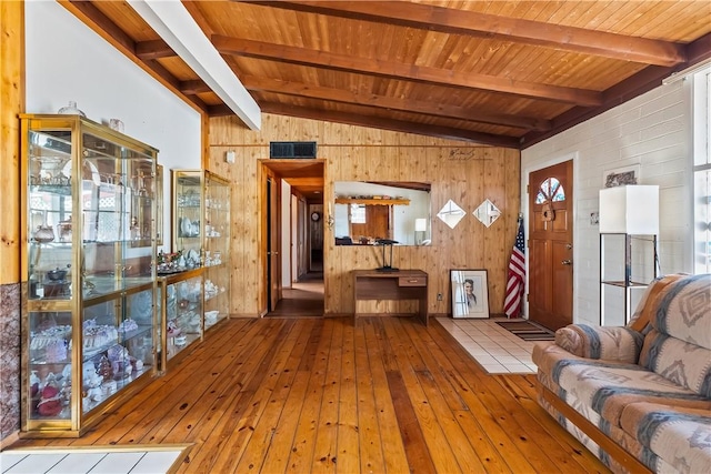 living room featuring wood-type flooring, wooden walls, and wood ceiling