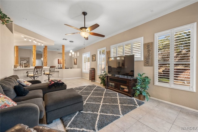 living area with crown molding, light tile patterned floors, visible vents, a ceiling fan, and baseboards