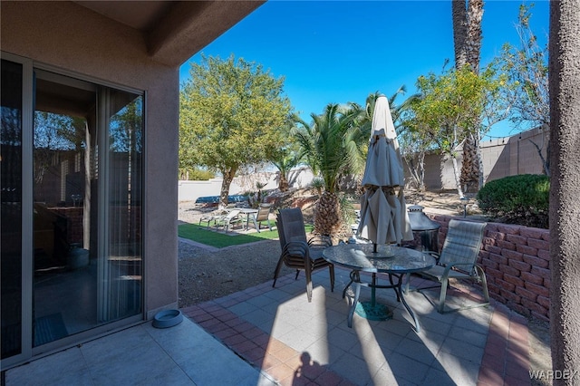 view of patio with a fenced backyard and outdoor dining area