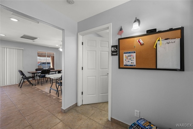 hallway featuring recessed lighting, light tile patterned flooring, visible vents, and baseboards