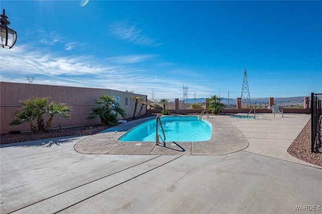 view of swimming pool featuring a fenced backyard, a fenced in pool, and a patio