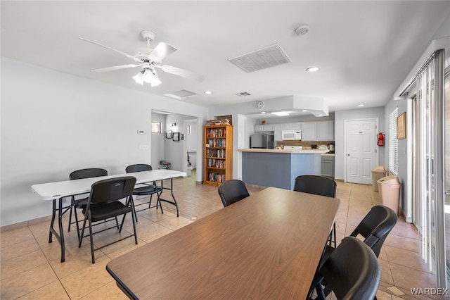 dining room featuring light tile patterned flooring, visible vents, and recessed lighting