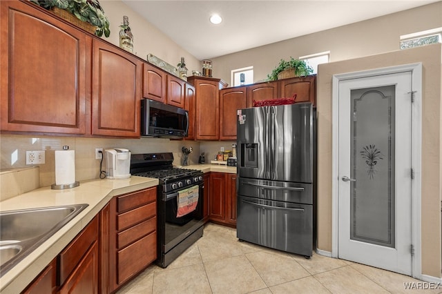 kitchen with light tile patterned floors, stainless steel appliances, recessed lighting, light countertops, and a sink