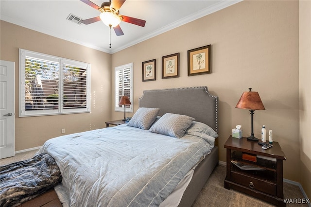 bedroom with baseboards, visible vents, dark colored carpet, and crown molding